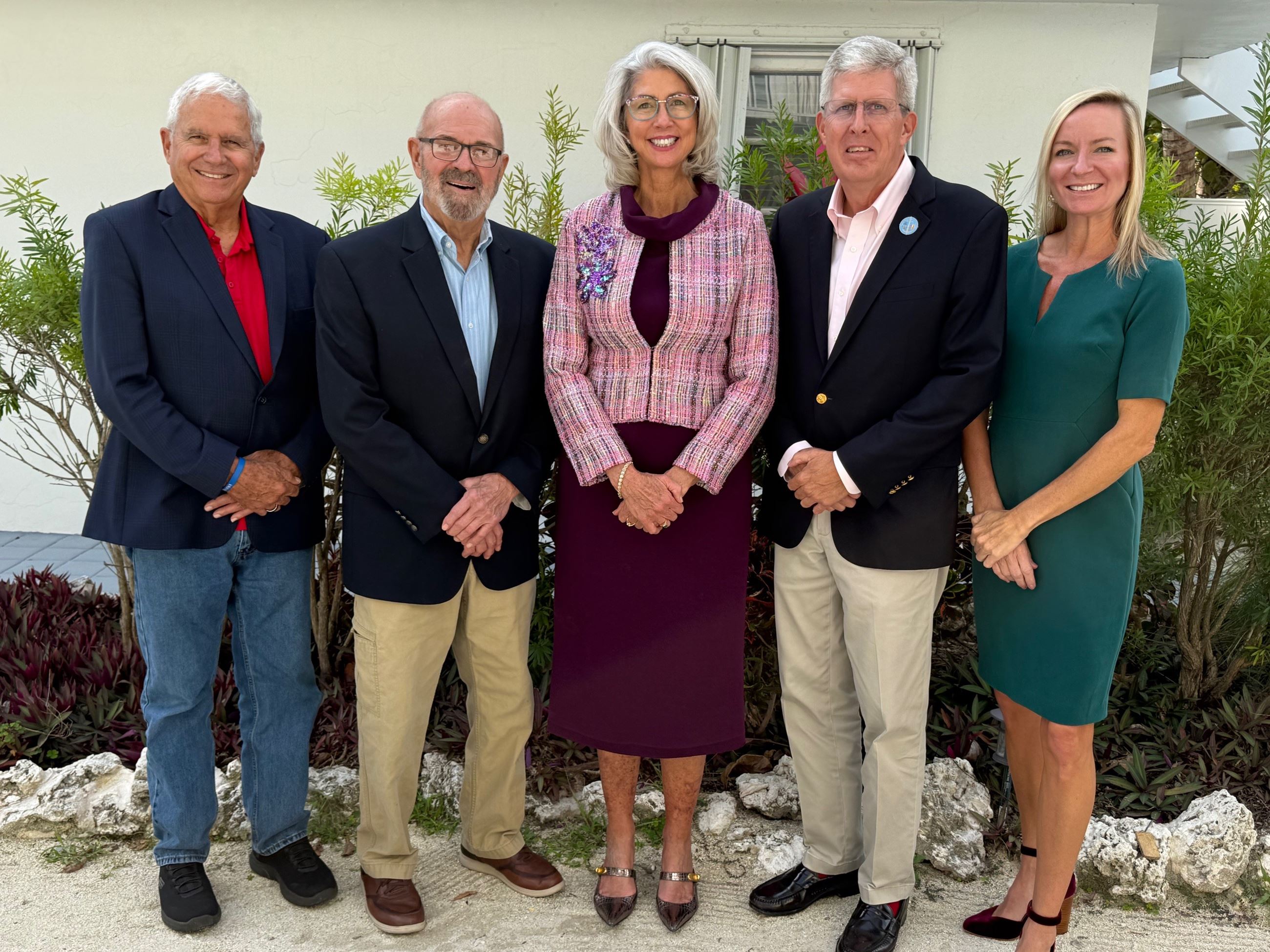 The five commissioners pose for a picture outside